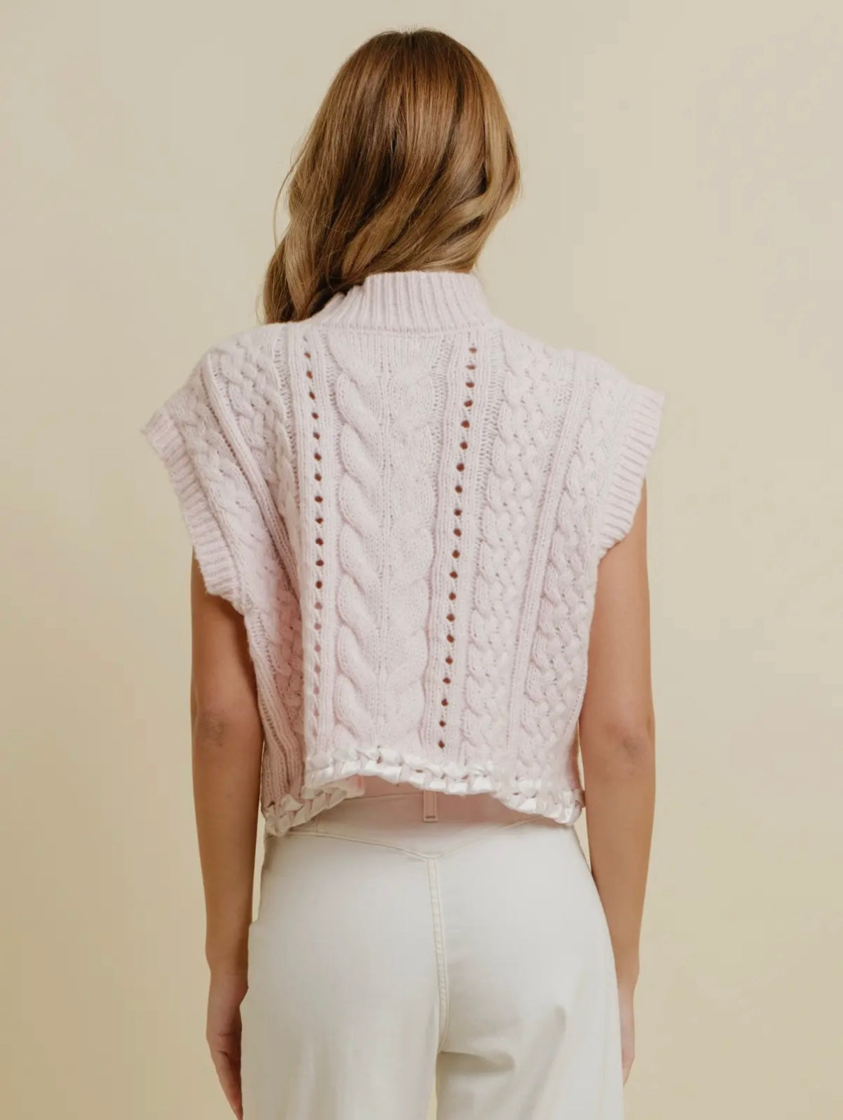 Pink and white sleeveless sweater