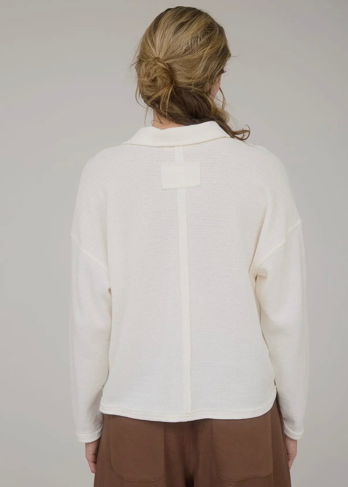 Cream exposed seam top